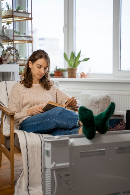 Full shot woman reading at home