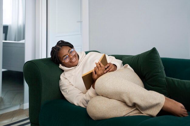 Full shot woman reading at home