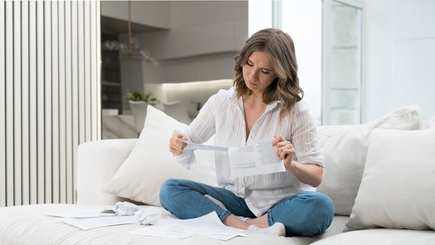Free photo full shot woman reading papers