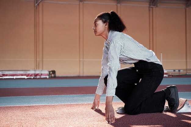 Full shot woman ready to run in suit