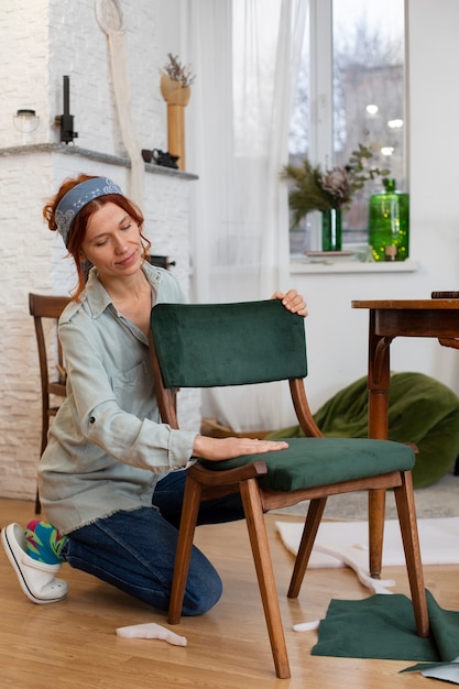 Free photo full shot woman restoring furniture