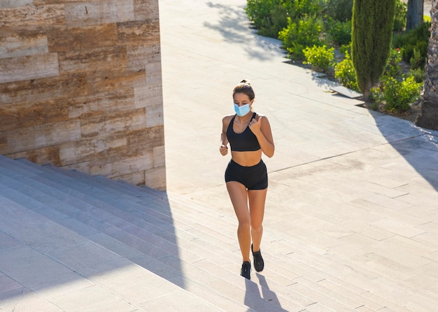 Full shot woman running with mask