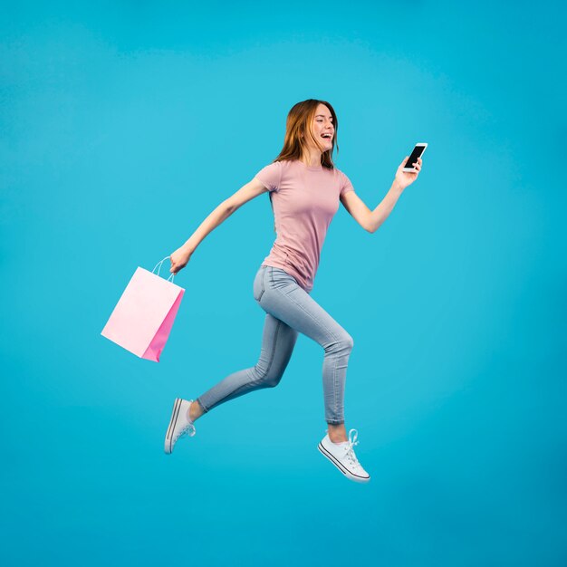 Full shot woman running with phone