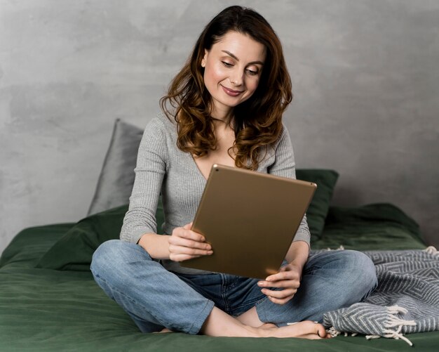 Full shot woman sitting in bed