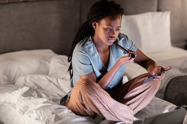 Full shot woman sitting in bed