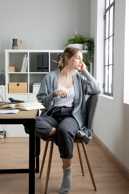 Full shot woman sitting on chair