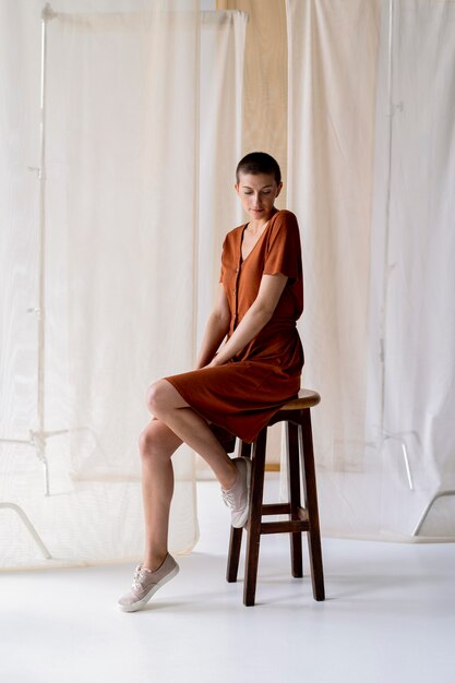 Full shot woman sitting on chair