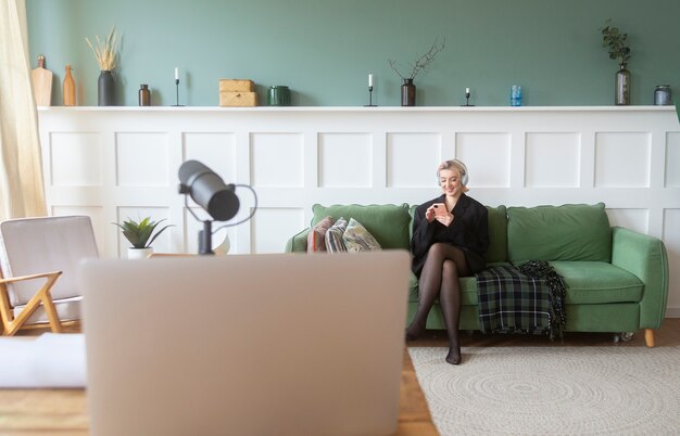 Full shot woman sitting on couch