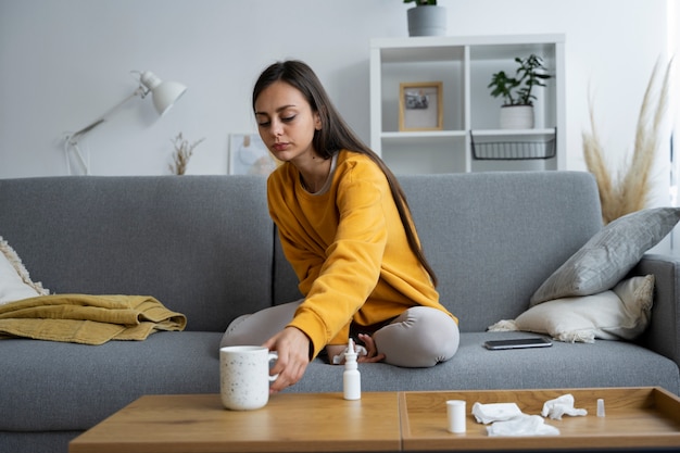 Free photo full shot woman sitting on couch