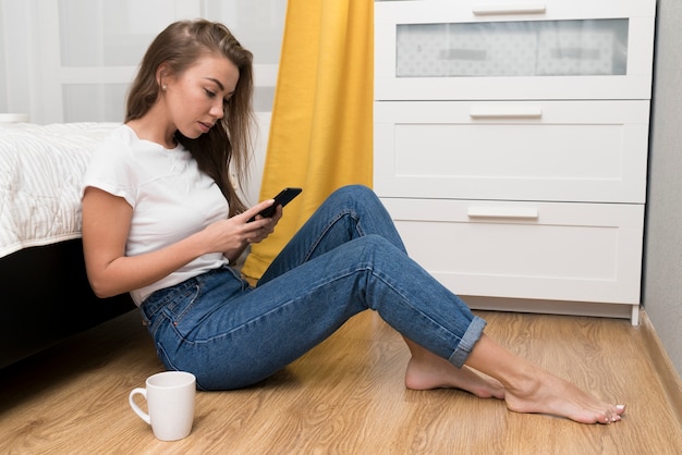 Full shot woman sitting on floor