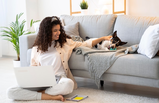 Full shot woman sitting on floor