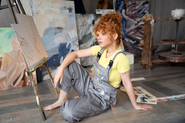 full shot woman sitting on floor