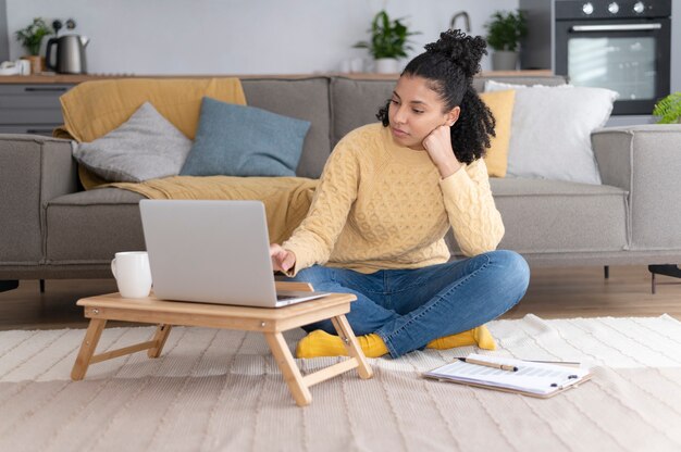 Full shot woman sitting on floor