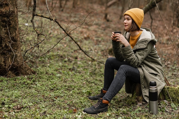 Full shot woman sitting on grass