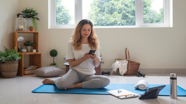 Free photo full shot woman sitting on mat