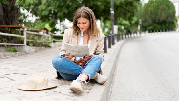 Full shot woman sitting outdoors