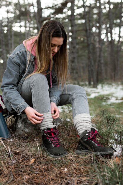 Full shot woman sitting outdoors