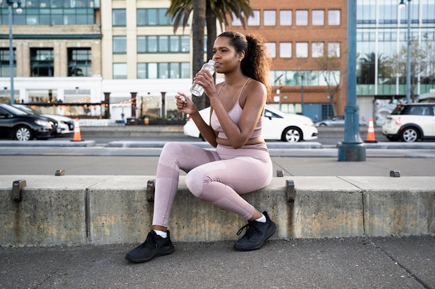 Full shot woman sitting outdoors