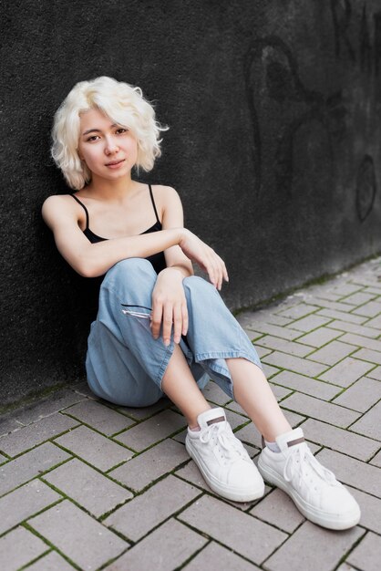 Full shot woman sitting outdoors