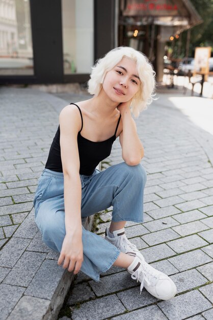 Full shot woman sitting outside