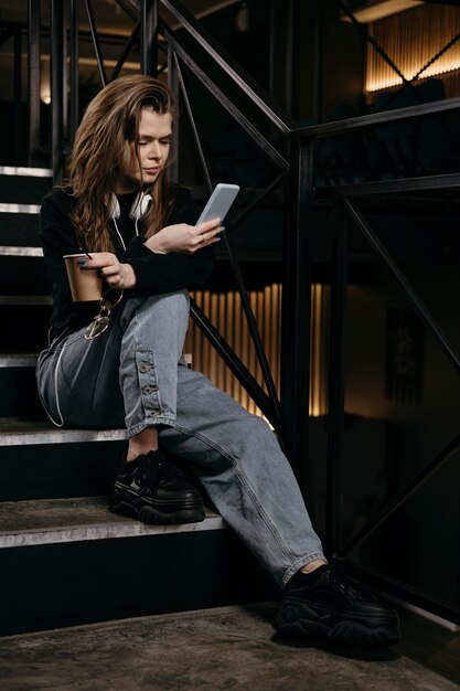 Full shot woman sitting on stairs