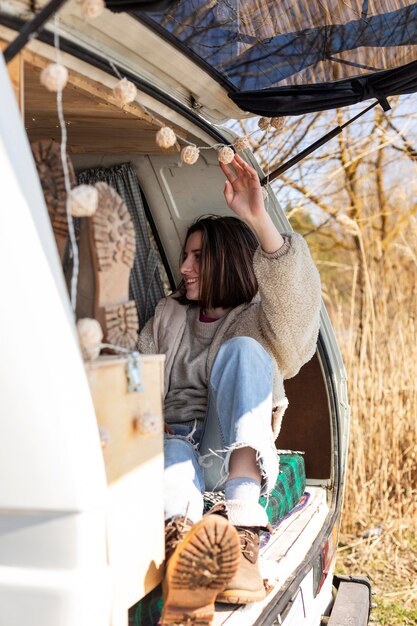 Full shot woman sitting in van