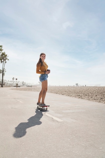 Full shot woman on skateboard