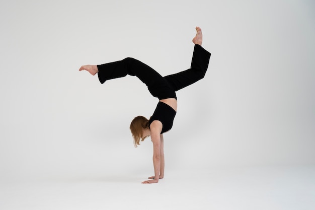 Full shot woman standing on hands