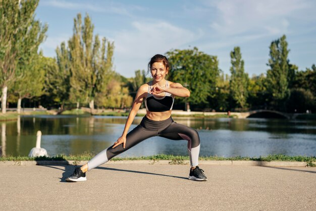 Full shot woman stretching her legs