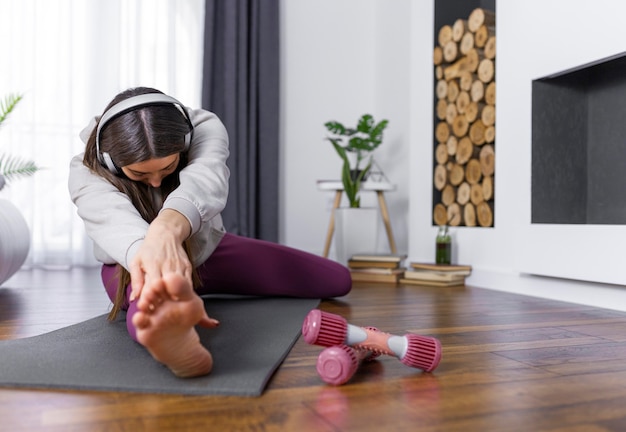 Full shot woman stretching leg