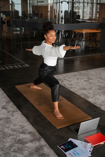 Full shot woman stretching at work