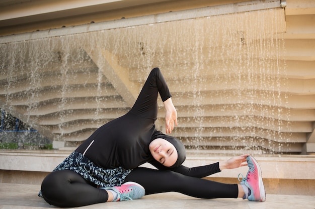 Free photo full shot of woman stretching