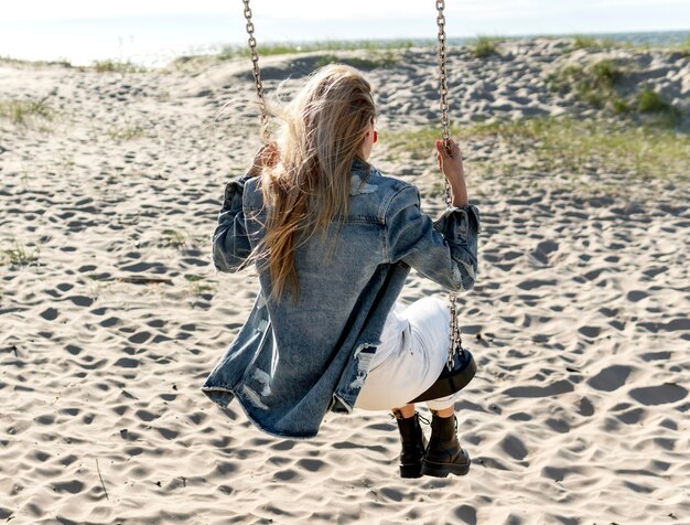 Full shot woman on swing