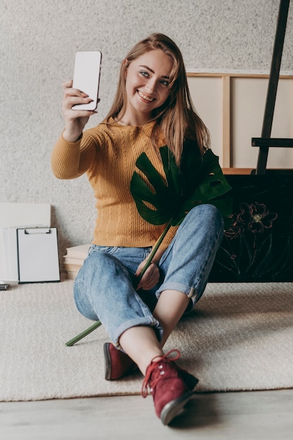 Full shot woman taking selfie