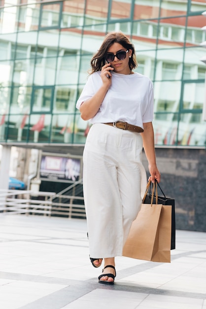 Full shot woman talking on the phone 