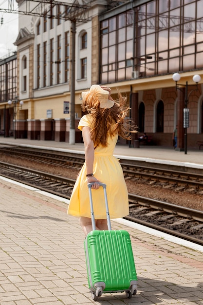 Free photo full shot woman at train station