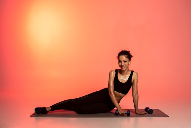 Full shot woman training on mat