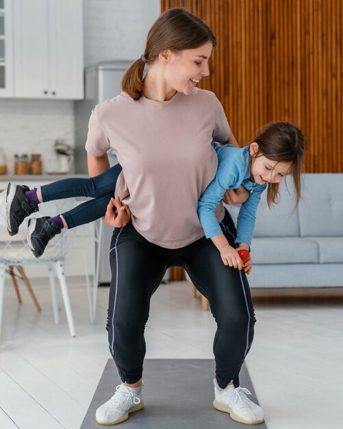 Full shot woman training with kid