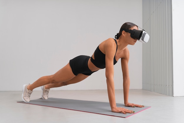 Full shot woman training with vr glasses on