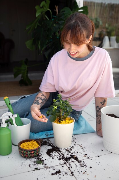 Full shot woman transplanting plants