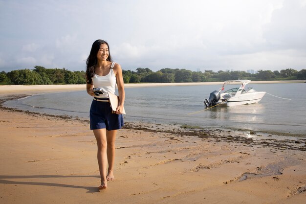 Full shot woman walking on beach