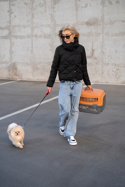 Full shot woman walking cute dog