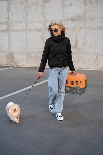 full shot woman walking cute dog