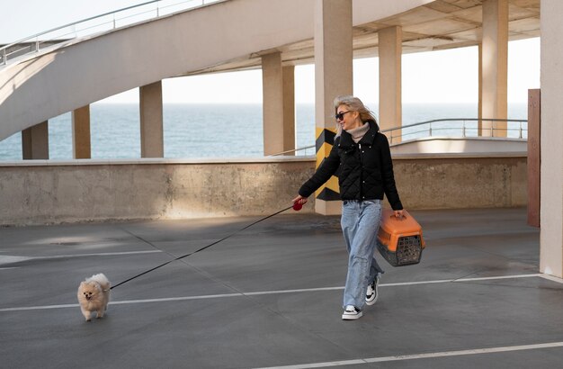 full shot woman walking cute dog