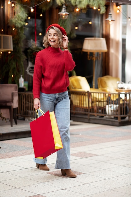 Free photo full shot woman walking with shopping bag