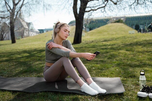 Full shot woman wearing headphones