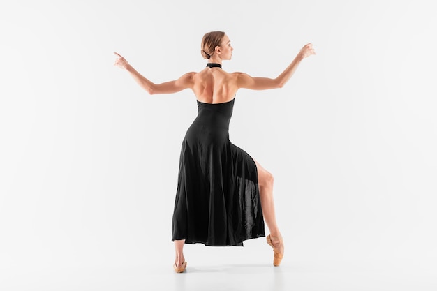 Full shot woman wearing pointe shoes and dress