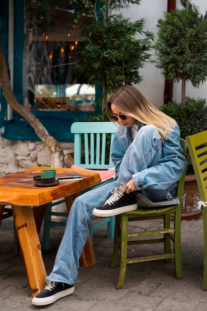 Free photo full shot woman wearing total denim outfit