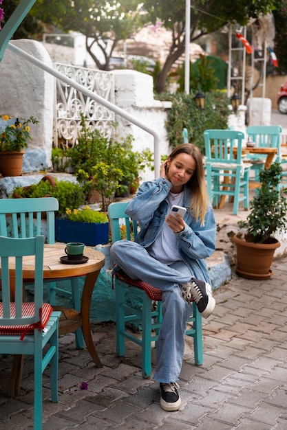 Free photo full shot woman wearing total denim outfit