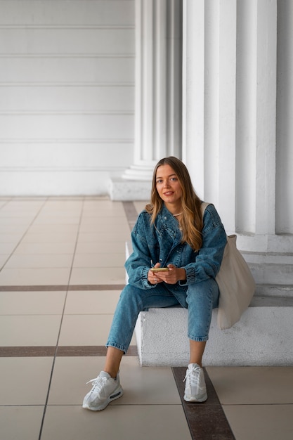 Free photo full shot woman wearing total denim outfit